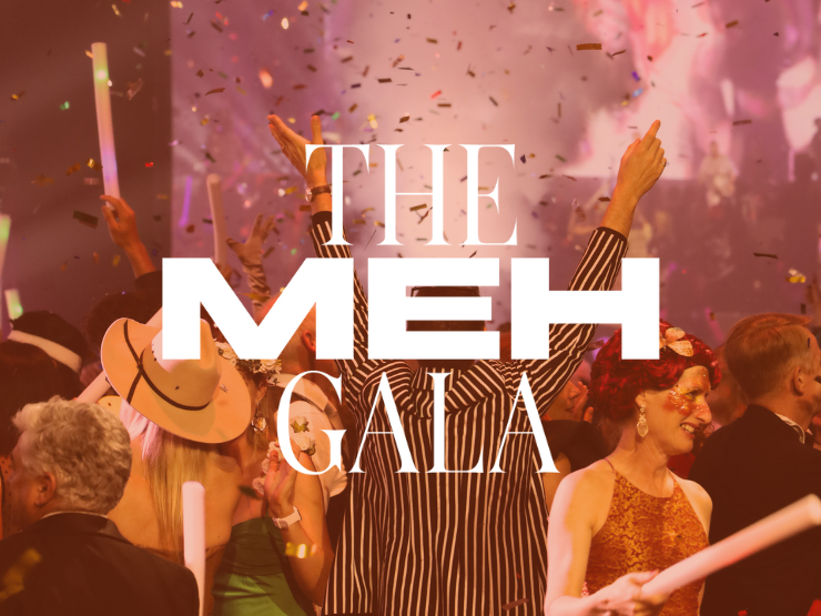 Man on a busy dance floor with his arms in the air as confetti falls around him. Over the top 'The MEH Gala' is written in white text.
