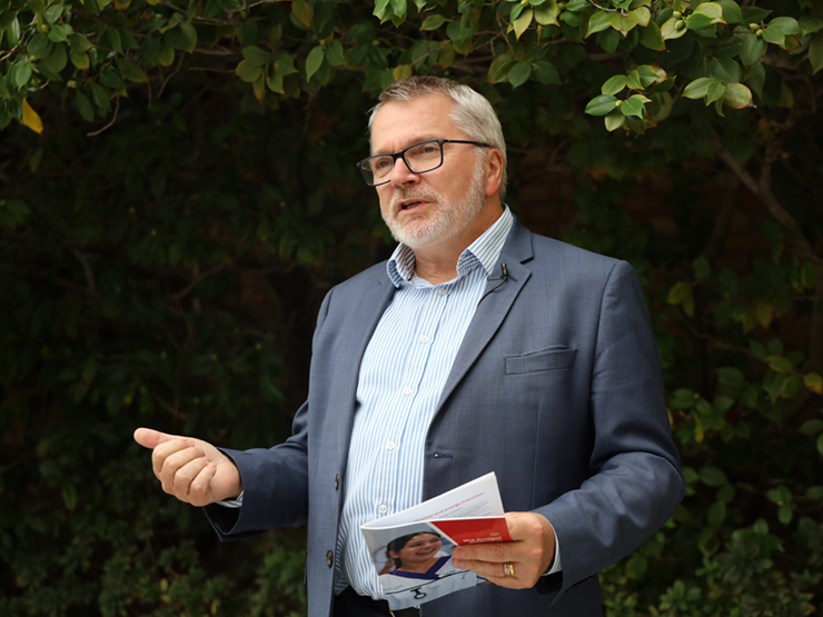 Mark Glasson CEO standing speaking to people who are out of shot.