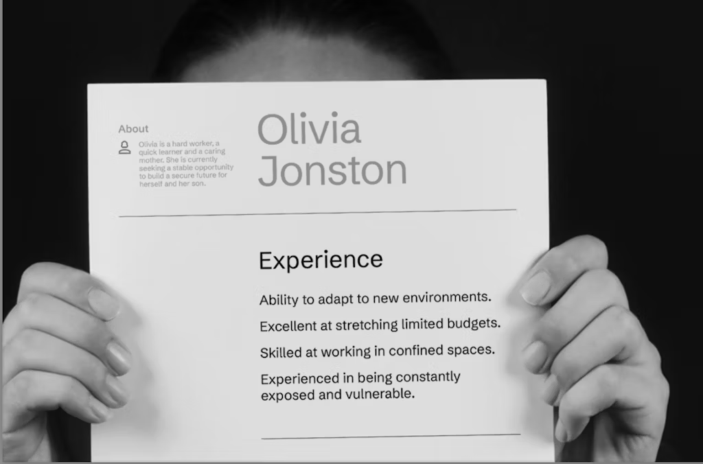 Part of the homelessness campaign with a black and white image of someone holding up a resume about their life 
