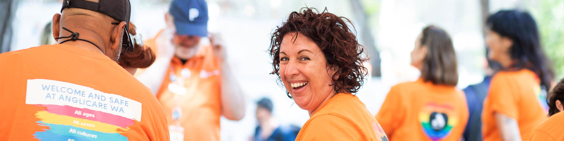 Happy woman staff member simling at camera at community event