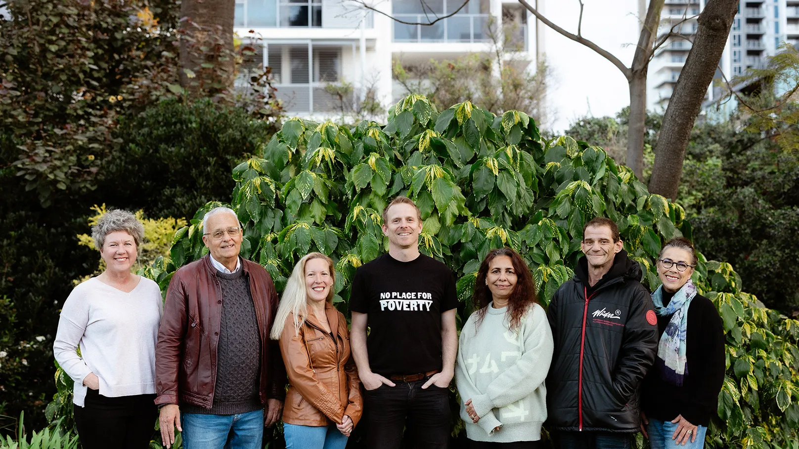 Seven people standing together outdoors in Boorloo Perth for No Place for Poverty. 