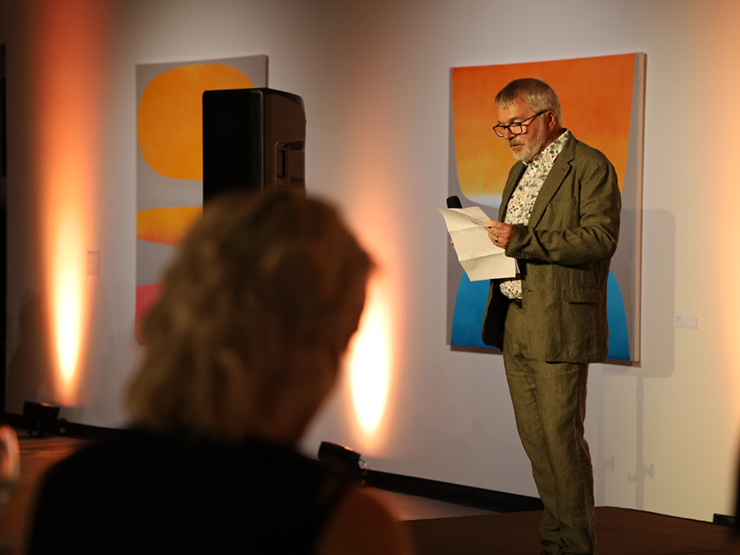 An image of CEO Mark Glasson speaking to a crowd of people.
