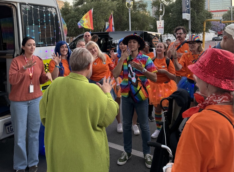 Anglicare WA workers signing AUSLAN at Perth's Pride Parade 2025.