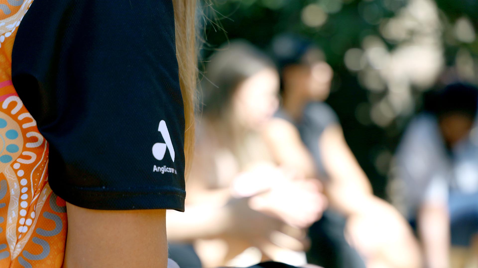 close up of Anglicare WA logo on workers uniform
