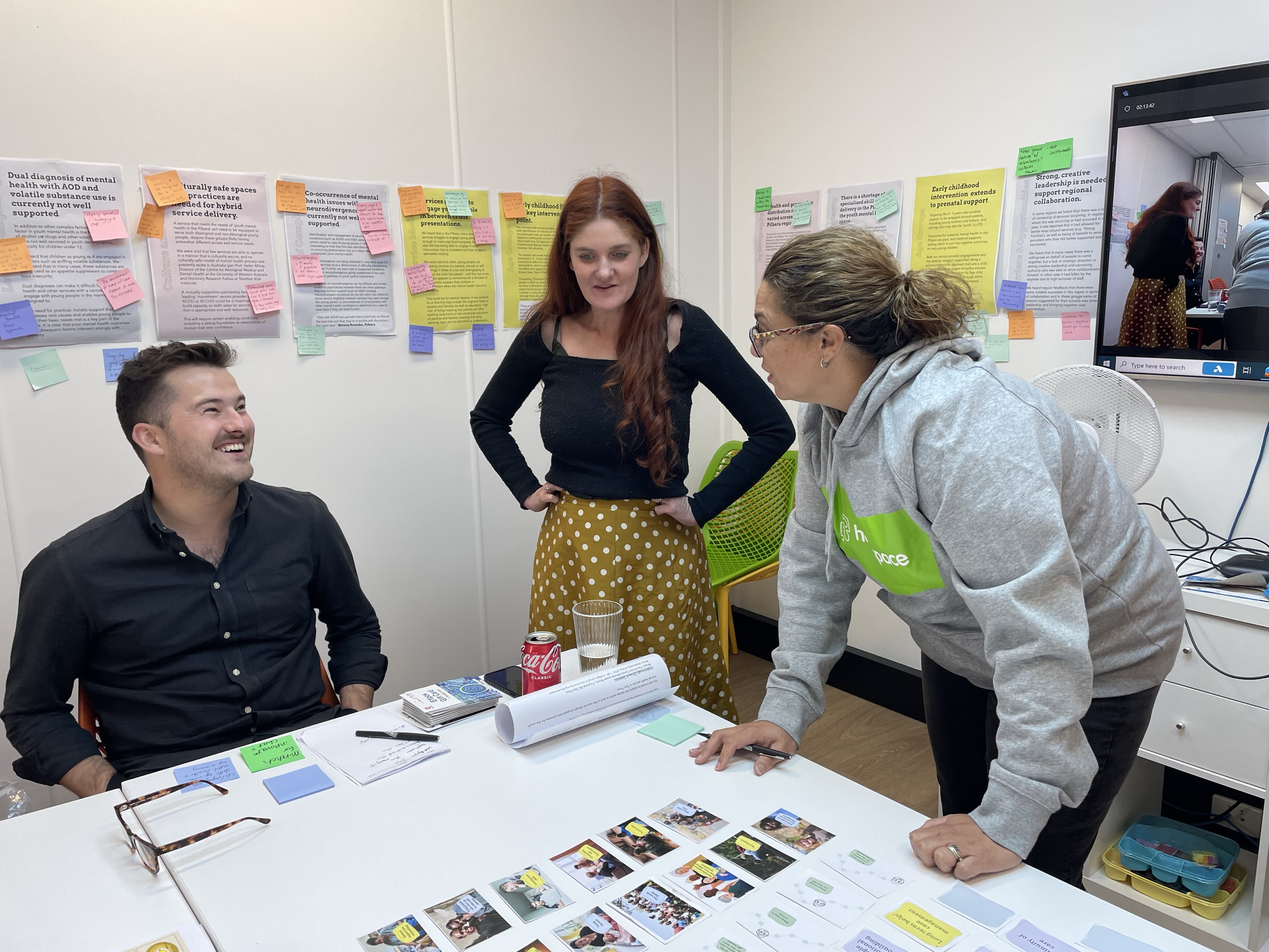 three people around a planning table