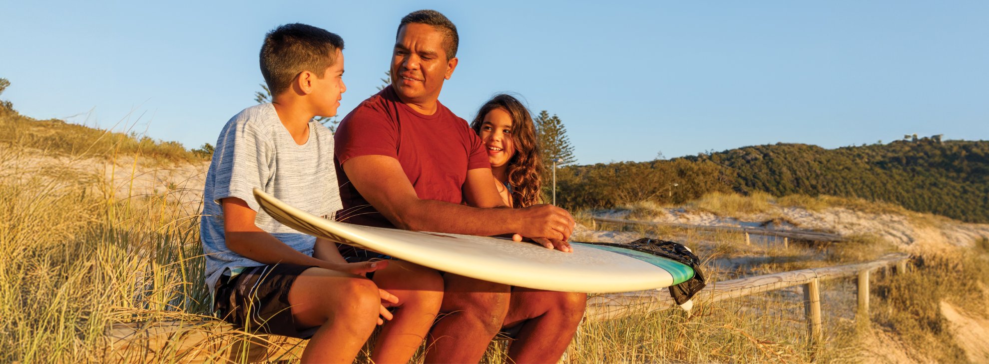 Photo of Newsletter banner showing father with two kids.