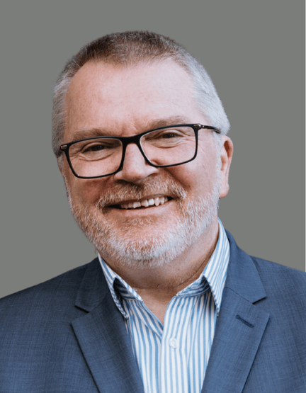 Headshot of Mark Glasson on a grey background