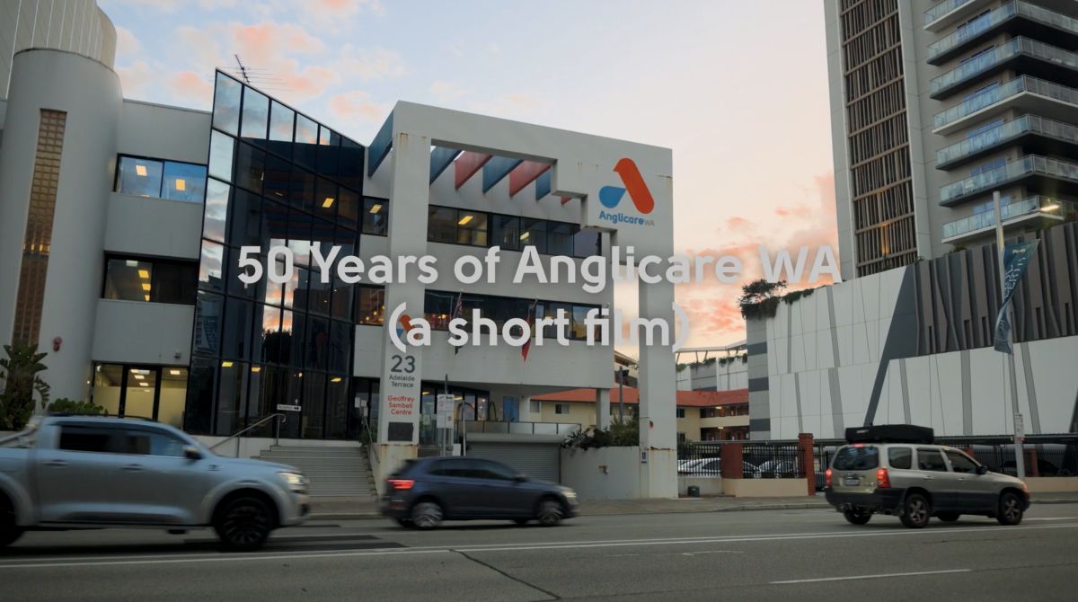 A photo of the exterior of the Anglicare WA East Perth building during golden hour.