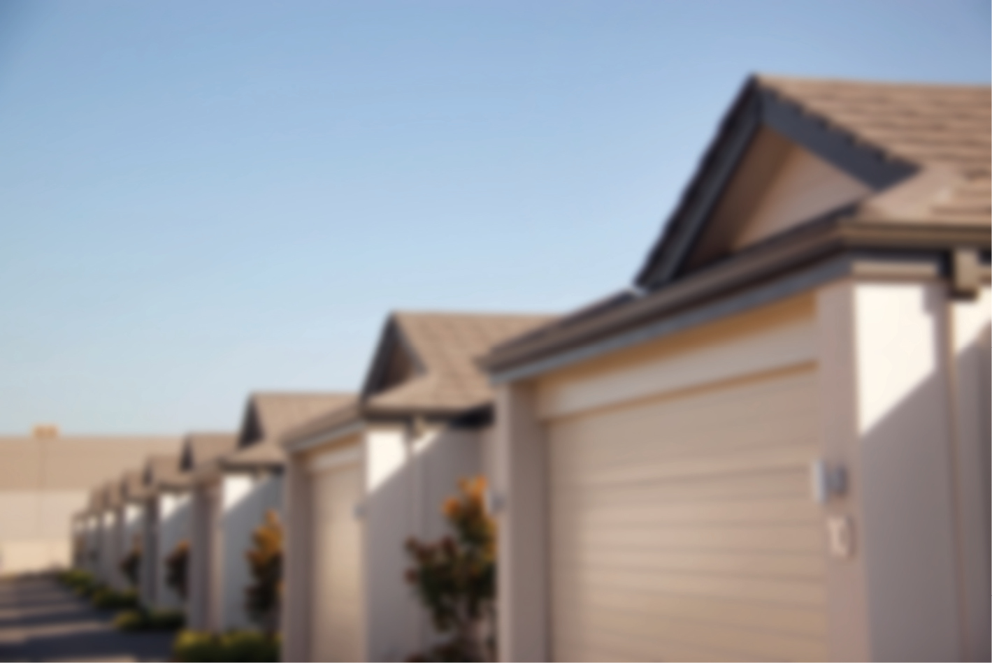 Picture of several identical modern houses in a row.