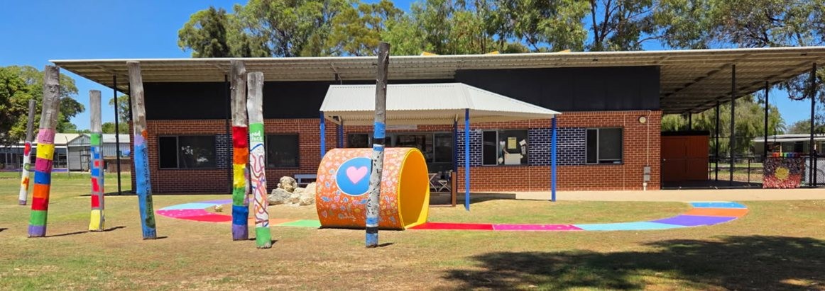 The front entrance of CPC Dudley Park with brightly painted timber poles and pathways.