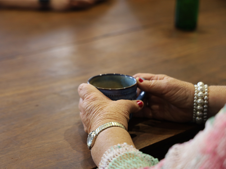 Close up of a lady's hands who is having a cup of tea.