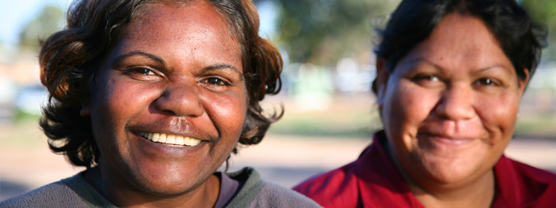 Two Aboriginal women smiling at camera