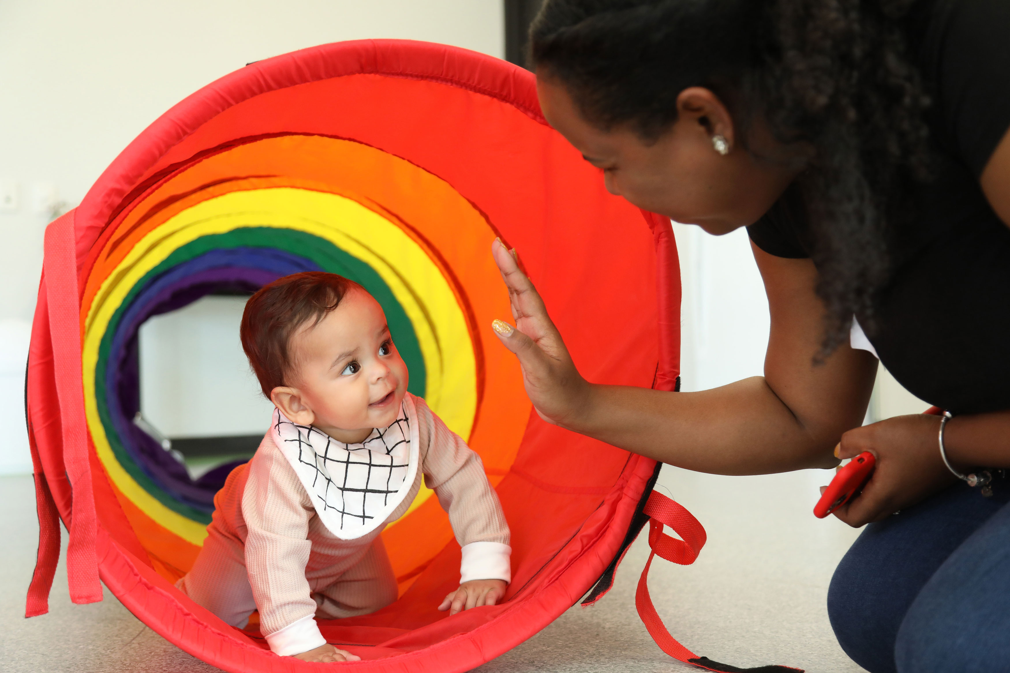 Young mother and daughter playing with balloon